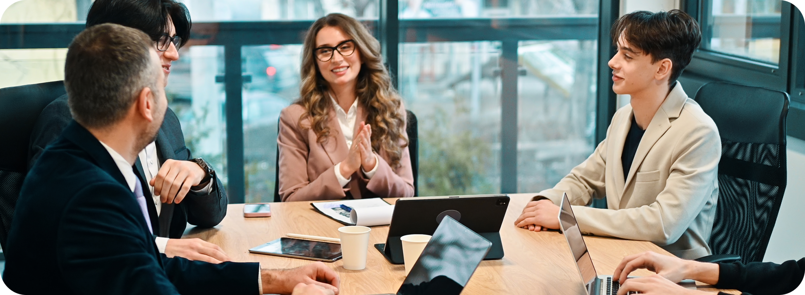 Compose Sales Partners working with a client leadership team around a boardroom table