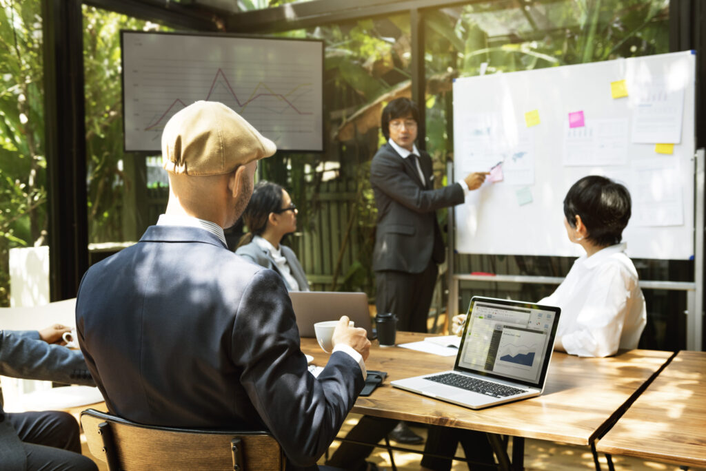A sales operations lead presenting pipeline and CRM data on screen to colleagues